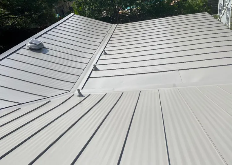 Solar attic fan installed on a metal roof for Roof Ventilation in Lakewood